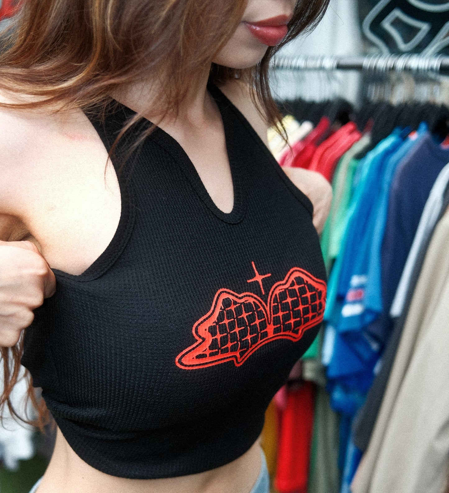 Girl wearing a red blem wing tank top