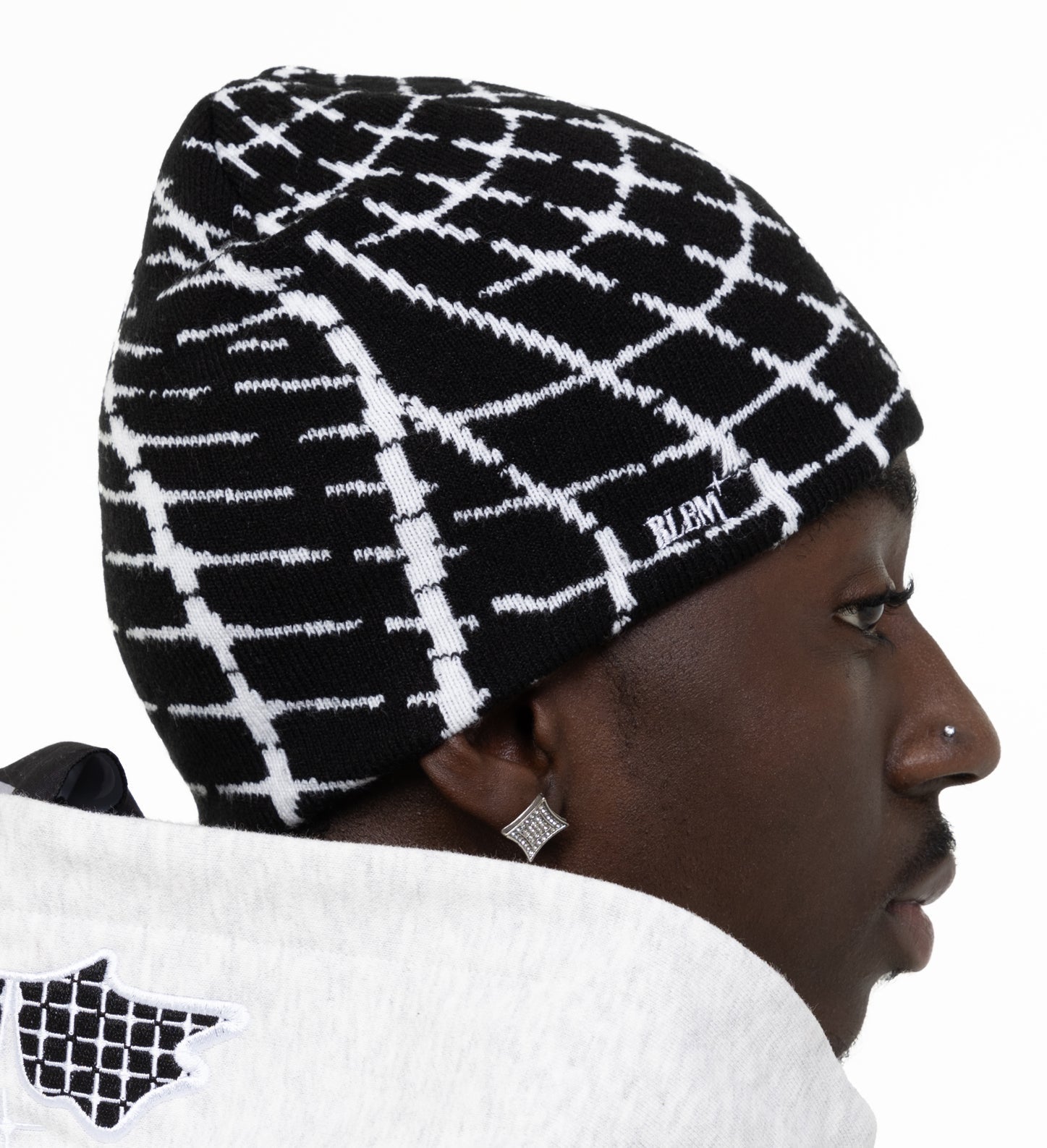 man wearing a black and white beanie with the word blem embroidered on the side